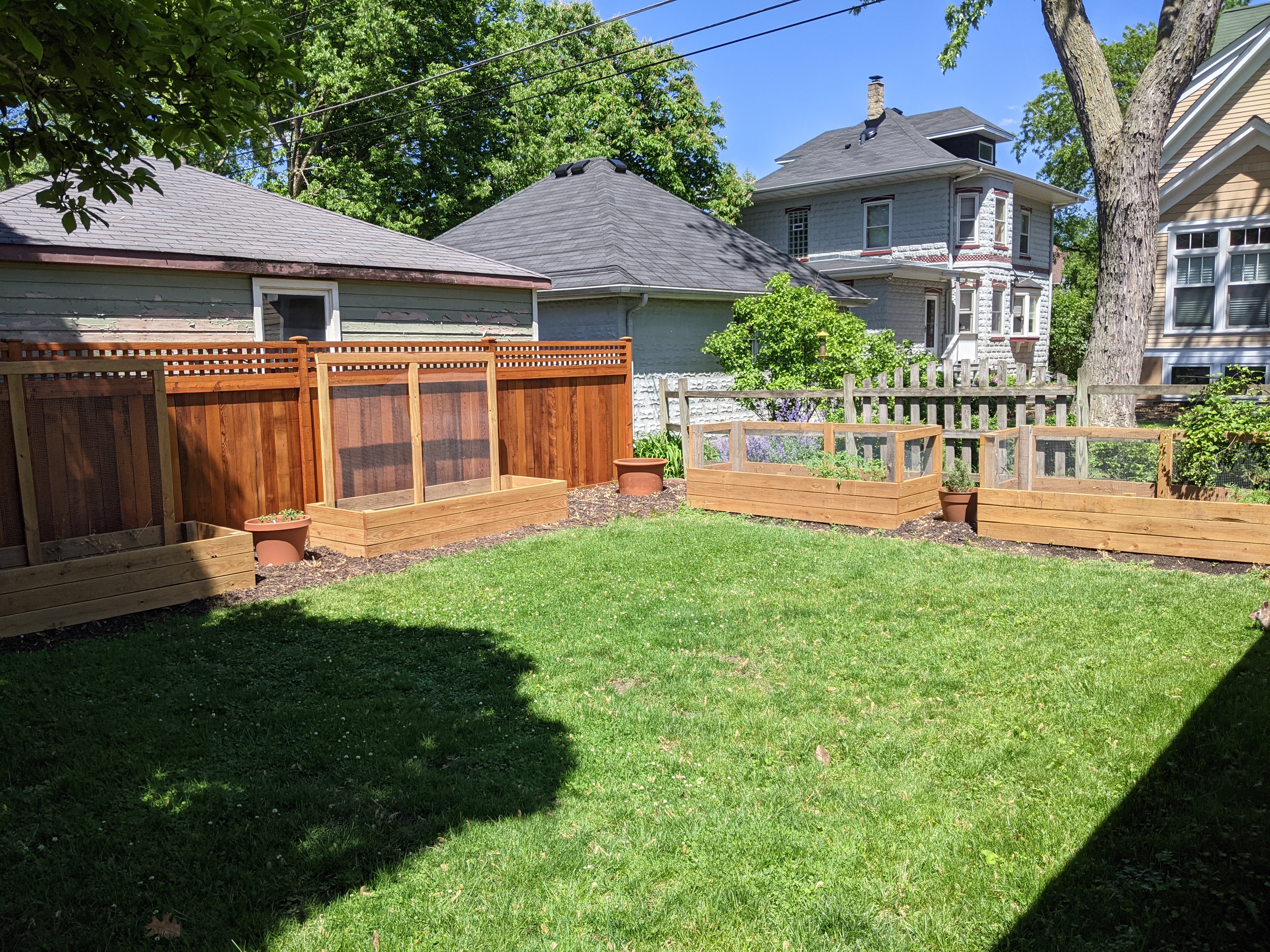 Finished cedar raised garden boxes installed outdoors.